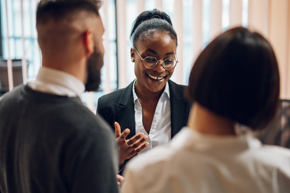 A female emoployer discussing her career development plan to her employees.